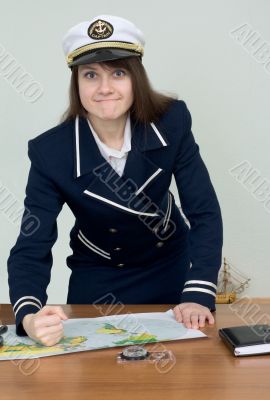 Woman in a sea uniform at table with map