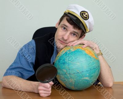Man in uniform cap with globe Man in uniform cap with globe