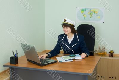 Portrait of the girl in a sea uniform at a table Portrait of the girl in a sea uniform at a table