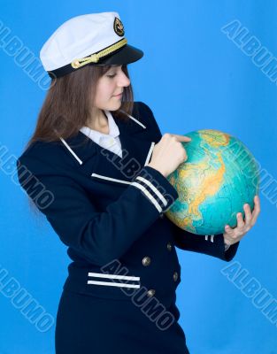 Woman in sea uniform and globe