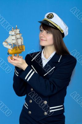 Portrait of the woman in a sea cap with the ship