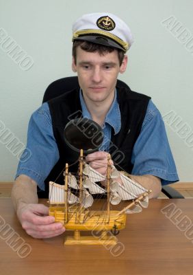 Man in uniform cap with sailer