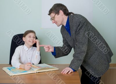 Tutor and schoolgirl with atlas