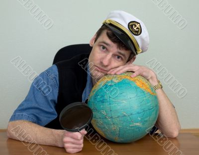 Guy in a sea cap with a globe