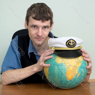Man with the globe and a cap