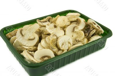 Sliced champignon mushrooms in green pack
