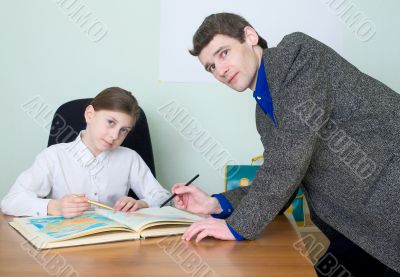 Tutor and schoolgirl with atlas