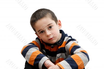 Serious cute little boy sitting