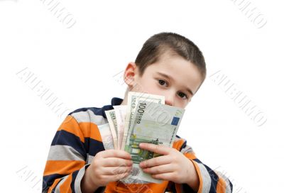 Cute little boy hides behind banknotes