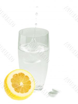 glass with water and aspirin pills