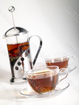 french-press withpair cups of tea and trickle steam