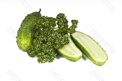 Cutted cucumbers and parsley, healthy food isolated on white Cutted cucumbers and parsley, healthy food isolated on white