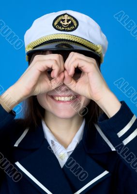 Funny girl in a sea uniform emits binoculars