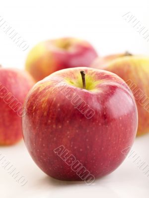 a few apples with shadow on bright background. selective focus
