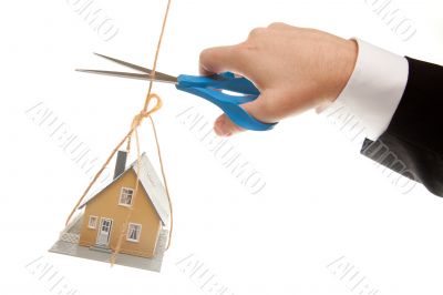 Hand with Scissors Cutting String Holding House Hand with Scissors Cutting String Holding House