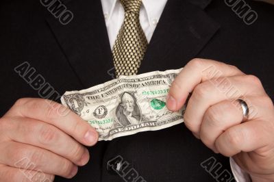 Businessman Holding Wrinkled Dollar Bill