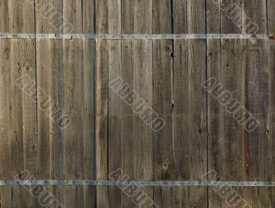 Old wooden fence with metal flat bar