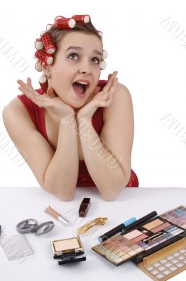 Woman with curlers in her hair looking surprised.