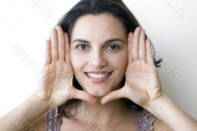 Young woman frame her face with palms