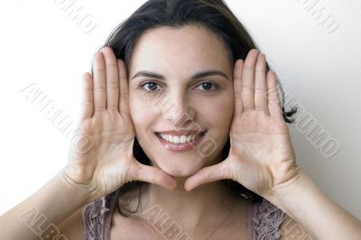 Young woman frame her face with palms
