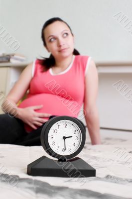 Pregnant woman and clock Pregnant woman and clock