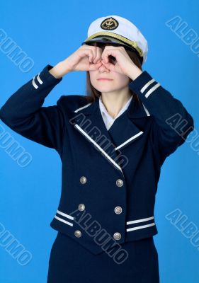 Girl in a sea uniform emits binoculars