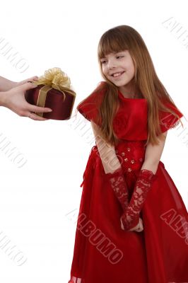 Little girl is getting gift. Girl feels shy.