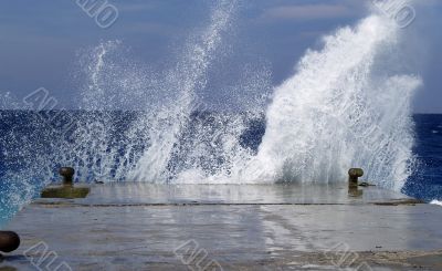 Wave breaking against stone mooring