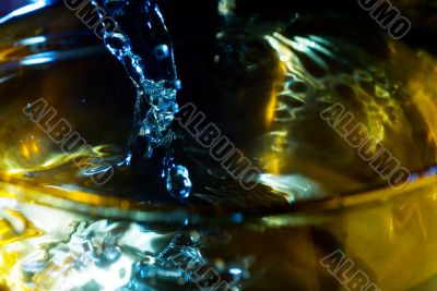 splash on clear glass with colored light