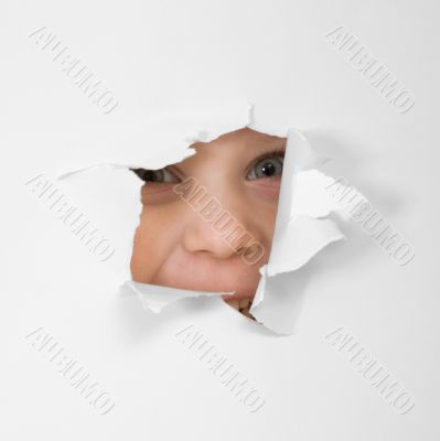 Eye looking through hole in sheet of paper