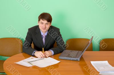 Businessman at a table with laptop Businessman at a table with laptop