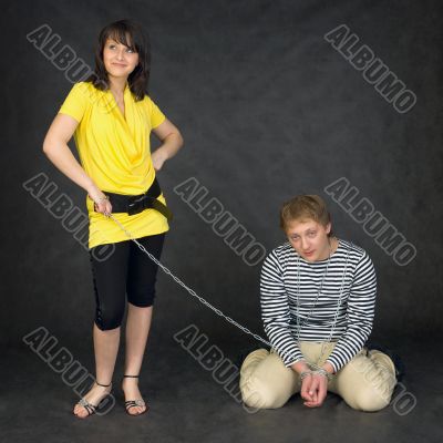 Guy chained in a chain and girl