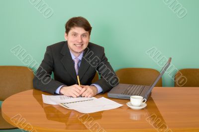 Businessman on a workplace with the laptop