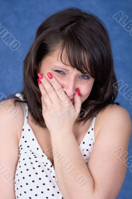 Upset girl on a dark blue background