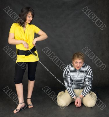 Guy chained in a chain and girl