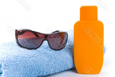 towel, sunglasses and lotion