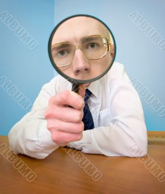 Man with a magnifier in a hand Man with a magnifier in a hand