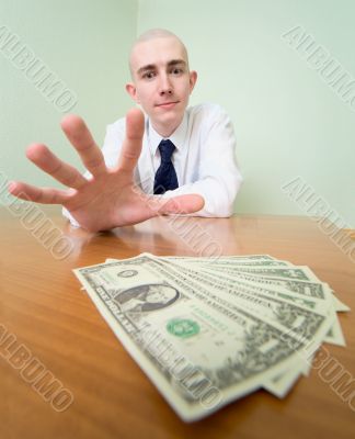 Man reaches for a batch of money Man reaches for a batch of money