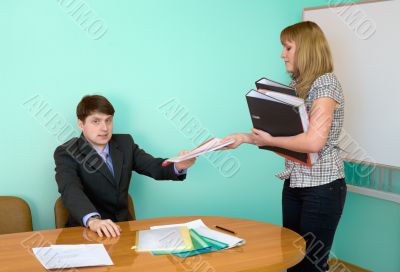 Secretary gives a folders to the chief