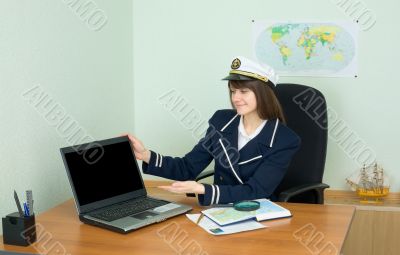 Girl - sea captain at office with laptop