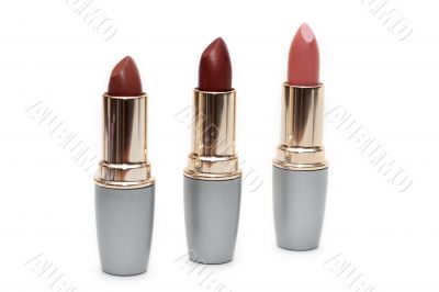 Three feminine lipsticks