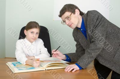 Tutor and schoolgirl with atlas