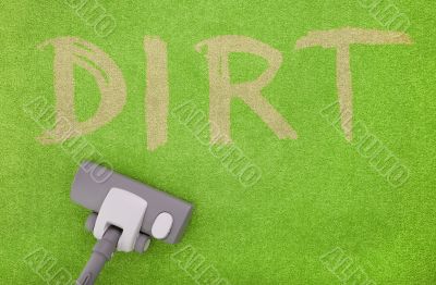 vacuuming dirt off a green carpet