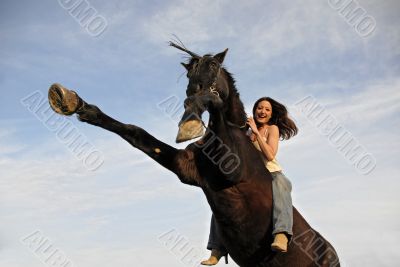 rearing stallion and laughing girl