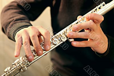 Flute player`s hands