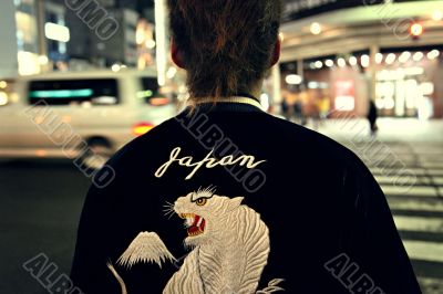 Young guy`s back with sign `Japan`