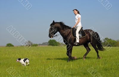 riding girl and her dog