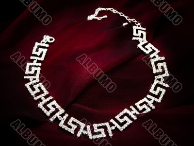 necklace at red fabric