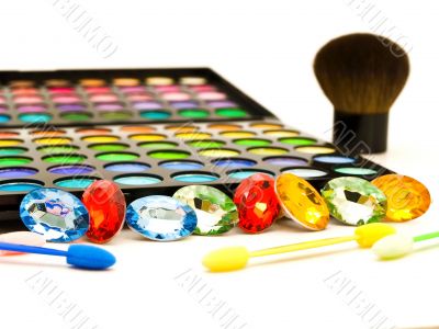 multicolored eye shadows and cosmetics brush