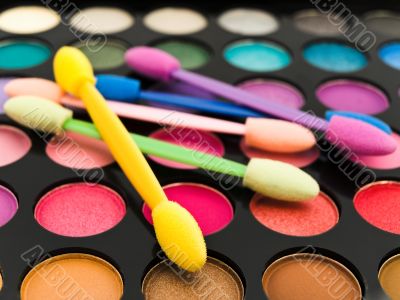 multicolored eye shadows and cosmetics brush